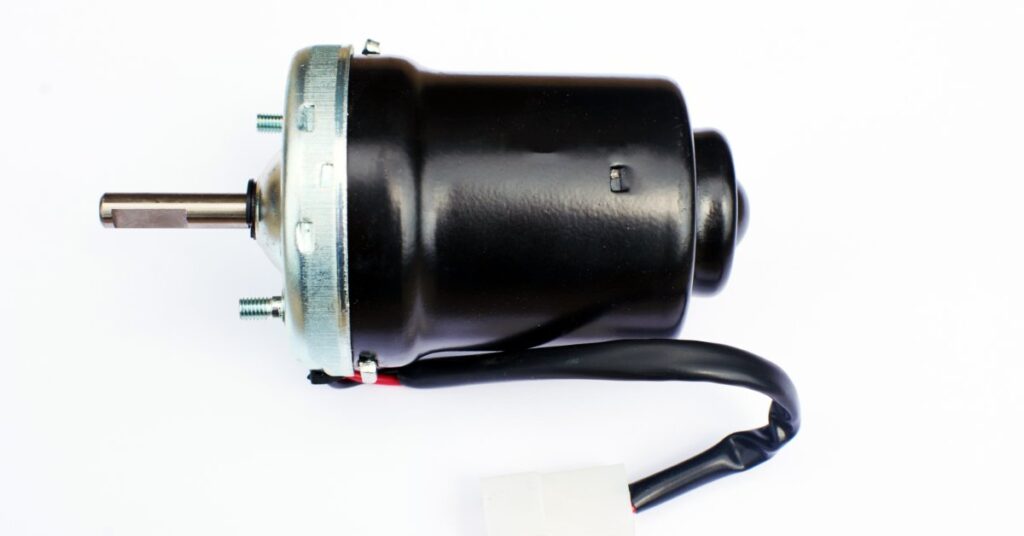 Heater blower motor with attached pump assembly, shown as an automotive replacement part isolated on a white background.
