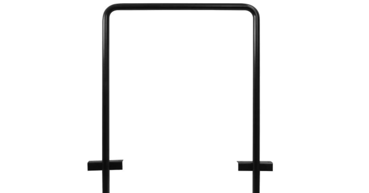 A black U-shaped wheel well mat storage holder stands upright on a plain white background with hardware attached.