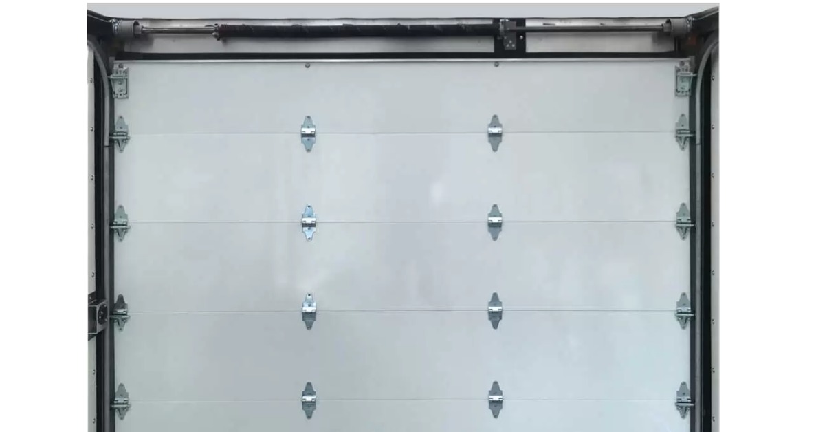A white steel roll-up door with the Todco style maximum security lock as replacement for step van doors.